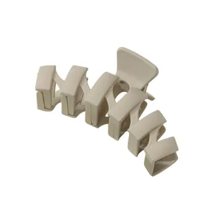 Detailed view of large matte cream hair claw clip with interlocking teeth for thick hair