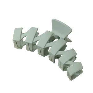 Close-up of matte green wavy hair claw clip showing durable interlocking teeth and strong spring