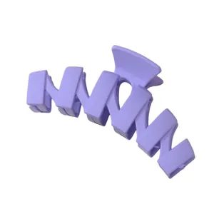 Macro detail of the lavender purple wavy hair claw clip with matte frosted texture