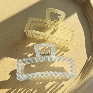Matte translucent square claw clips in yellow and cream white with bead texture