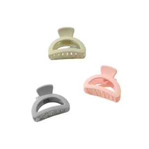 Three-piece set of mini matte hair claw clips in pastel green, pink, and grey shades