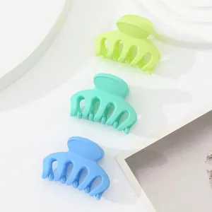 Three-piece mini matte hair claws in vibrant green, mint, and blue colors set