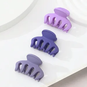 Close-up of 3-piece set matte purple mini hair claws with high-quality interlocking teeth