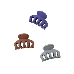 Detailed close-up of matte mini hair claws in purple, brown and grey Morandi tones