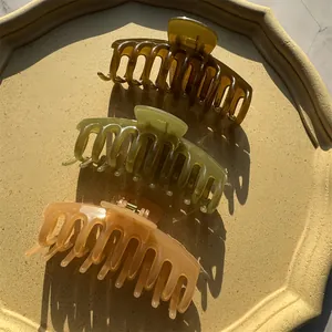 Three jelly color large claw clips in dark brown, olive green, and light orange