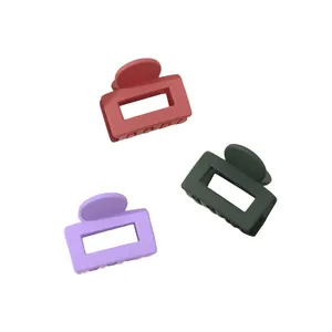 Detailed view of 3-pack mini matte claw clips in pink, dark green and light purple colors