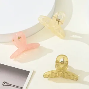 Three-piece matte resin mini hair claws in pastel pink, yellow, and olive green colors