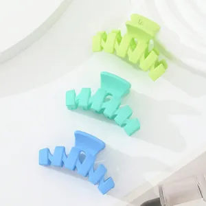 Macro detail of matte mini hair claws in neon green, mint, and sky blue set of three