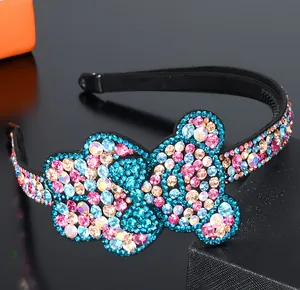 Macro shot of colorful rhinestones on a black headband with detailed bear-shaped crystals