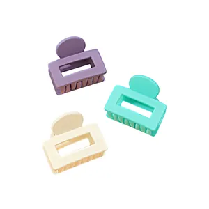 Detailed set of three matte square hair claw clips in purple, teal, and cream colors