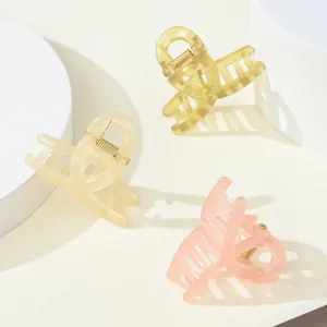Close-up of matte jelly texture resin hair claws in yellow, beige and pink tones