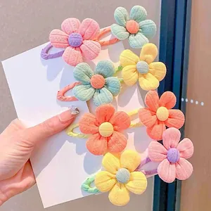 Detail of colorful fabric flower hair clips with textured petals and elastic bands