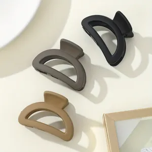 3-pack of small matte hair claws in neutral earth tones with minimalist hollow design