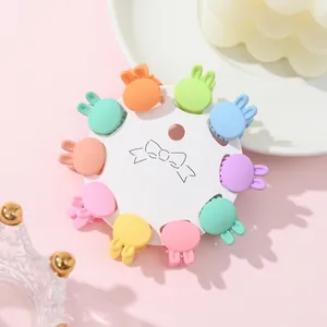 Macro view of ten colorful rabbit-ear mini hair claws on a circular display card