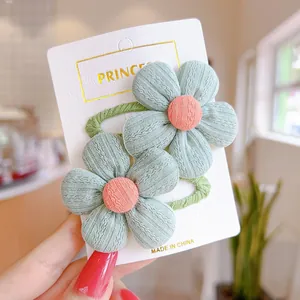 Detail of cute green floral hair clips with pink centers on a princess display card