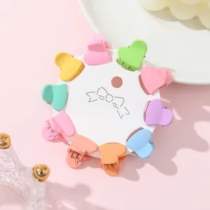 Macro detail of colorful heart-shaped matte plastic hair clips on display card
