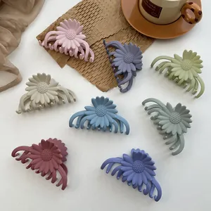 Detailed close-up of matte sunflower hair clips in seven assorted Morandi colors