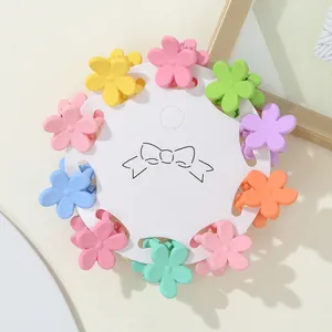Detailed set of multi-colored matte flower mini hair claws on a circular card display