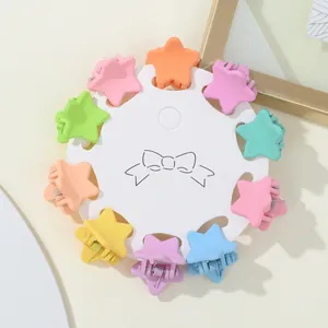 Detailed set of ten star-shaped matte pastel hair claws on a decorative card