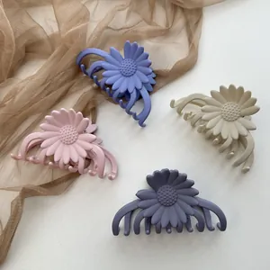 Set of four matte daisy flower hair claws in pastel pink, purple, beige and blue