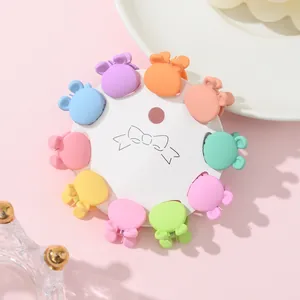Detailed view of 10 mini bear hair clips in macabre candy colors on a display card