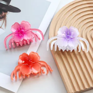 Set of 3 gradient frangipani flower hair clips in pink, orange, and purple hues