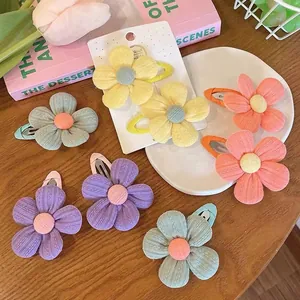 Cute fabric flower hair clips set for girls on a decorative background with pastel colors