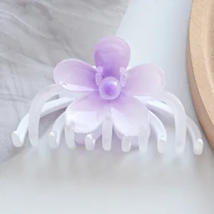 Detailed view of the purple flower hair claw clip with semi-transparent resin petals
