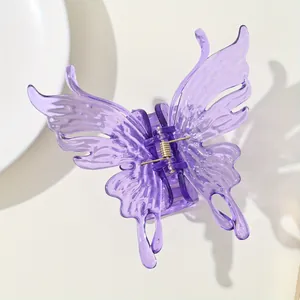 Close-up of a purple translucent butterfly hair claw clip with detailed wing patterns