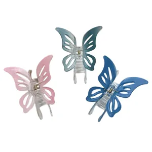 Three gradient hollow butterfly hair claws in pink, light blue, and navy acrylic