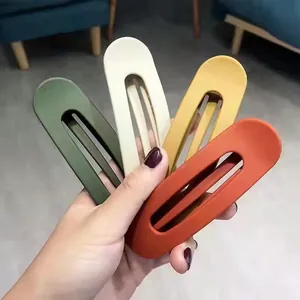 Detailed view of four matte duckbill hair clips in Morandi colors for women