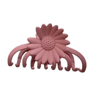Matte pink floral hair claw clip featuring a sunflower design for a sweet elegant style