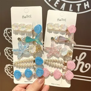 Ocean-themed hair clip set with resin shells, starfish and pearls on display card