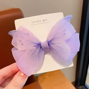 Detailaufnahme einer lila Schmetterlings-Haarspange aus Netzstoff auf einer Displaykarte