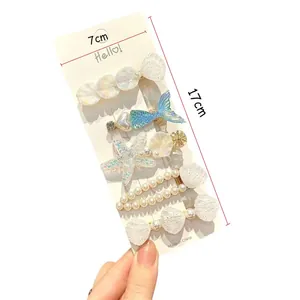 Detail of 5pcs ocean theme hair clip set with faux pearls and starfish on card