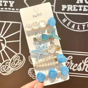 Detailed set of 5 blue ocean-themed hair clips with mermaid tails and faux pearls
