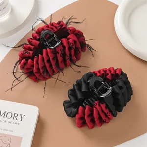 Large vintage fabric bubble hair claw clips with red fabric and black feather accents