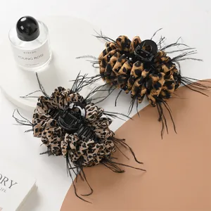 Elegant leopard print hair claw clips set with black feather trim and crystal accents