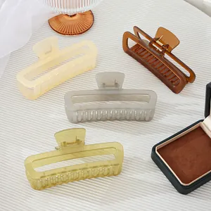 Set van vier minimalistische holle haarklemmen in geel, bruin, grijs en olijfgroen