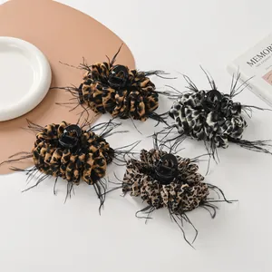 Leopard print hair claw clips with feather accents and crystal rhinestones set of four
