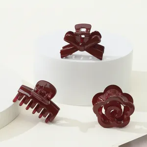 Three-piece deep red hair claw set featuring bow, rose, and classic shark clip styles