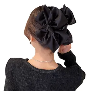 Elegant large black satin bow hair clip for women with multi-layer textured ribbon design