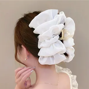 Detailed back view of a white oversized organza lace hair claw clip worn in hair
