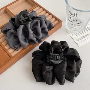 Elegant large grey and black bow hair claws with bubble fabric texture and patterns