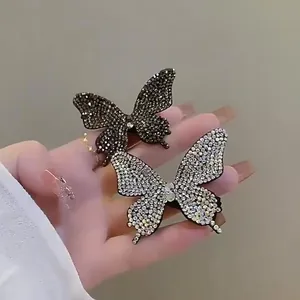 Fermagli per capelli a farfalla scintillanti con cristalli neri e argento