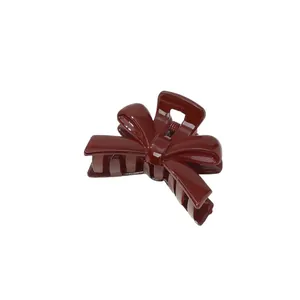 Elegant deep red bow-shaped hair claw clip with high-gloss finish for women