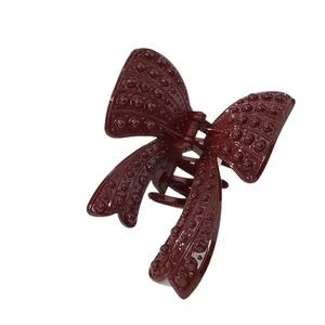 Elegante pinza per capelli a farfalla rosso vino con finitura lucida strutturata