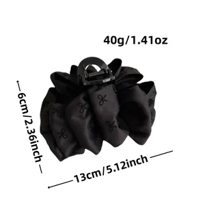 Large black bubble bow hair claw clip with floral pattern and dimensions displayed