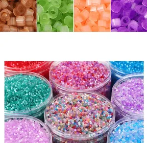 Macro shot of colorful glass seed beads set in transparent jars for DIY jewelry making