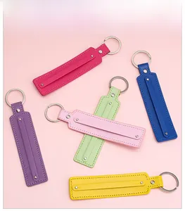 Flat lay of colorful leather keychains with metallic rings and detailed stitching